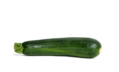 Fresh green zucchini isolated on a white background. Zucchini ready to cook. Zucchini lies on the counter, the concept of cooking and preparing a meal. Dishes for vegetarians.