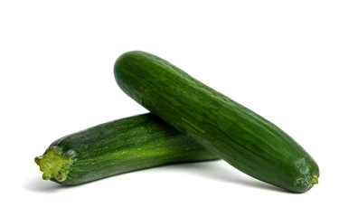 Green cucumber and zucchini isolated on a white background. The concept of eating vegetables, providing vitamins and healthy eating. Comparison of courgettes and cucumbers.