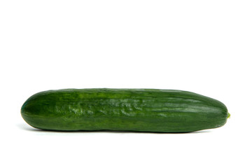 Green cucumber Isolated on white. Ground cucumber ready to be cooked. The cucumber lies on the counter, the concept of cooking and preparing a meal. Dishes for vegetarians.