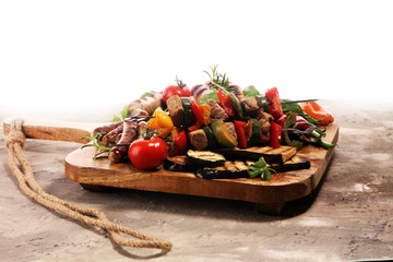 Assorted delicious grilled meat with vegetable on a barbecue. Grilled pork shish or kebab on skewers with vegetables . Food background shashlik