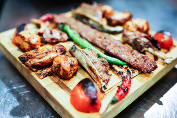 Traditional oriental Adana kebap and shashlik skewer with tomato and flatbread