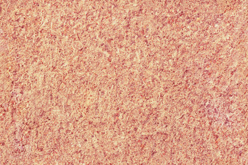 Seamless texture of a rough concrete wall of light orange-yellow color.