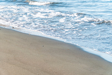 Fantastic soft wave layers on sand at the sea.