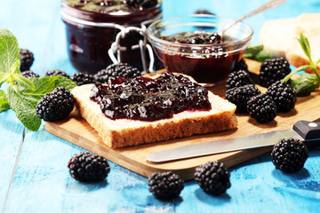 Toast bread with homemade blackberry jam or marmalade on table served with butter for breakfast or brunch