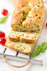 Snack cake with vegetables (zucchini, eggplant, carrot, tomato) and cheese. A tasty lunch, food, healthy baking