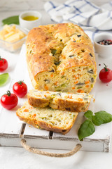 Snack cake with vegetables (zucchini, eggplant, carrot, tomato) and cheese. A tasty lunch, food, healthy baking