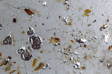 drops of molten metal and rosin on a metal soldering board, selective focus, close