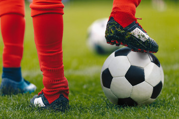 Fototapeta premium Close up soccer player with ball on grass field