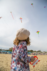 Cervia, Italy - 21/04/2019 Artevento 2019, Little girl let a unicorn kite fly