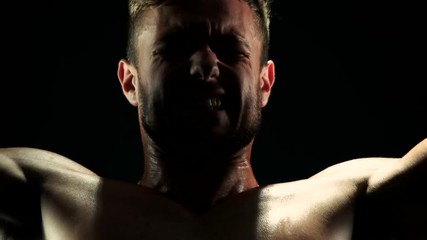 Close up sportsman lifting heavy weight. Handsome caucasian sporty man doing arms exercises with barbell close up. Bodybuilding and weightlifting.