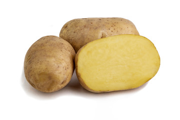 vegan diet: fresh raw organic potatoes, on white, short focus