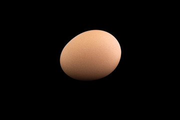 proper nutrition: chicken egg is isolated on a black background with shadows
