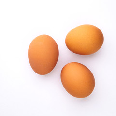 3 chicken eggs on a white background with shadows