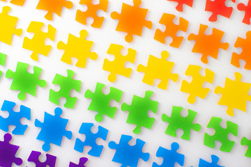 LGBT concept: gay flag of separate multi-colored puzzle on white, blur