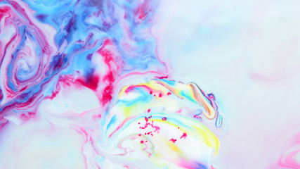 Fluid art. Multicolored abstract background on the liquid. Color pattern in the style of pop art. Multicolored fluid stains. Widescreen