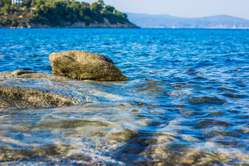 soft focus rocky stone tropic sea lagoon waterfront shoreline natural outdoor background with empty...