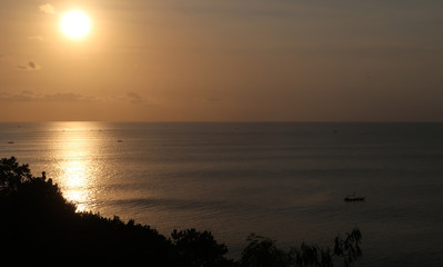 Fototapeta na wymiar Bali beach sunset with fishing boats and bright sky