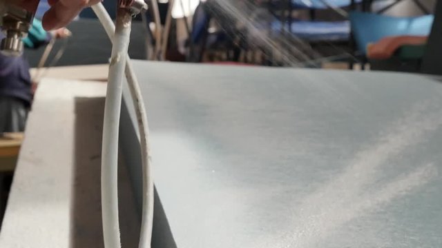 Close up of man gluing mattress in manufacture. Assembly process