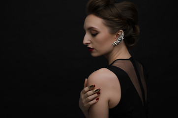 beautiful girl with jewelry on black background