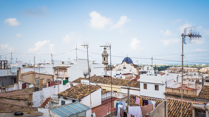 Fototapeta premium Aerial view of old town Oliva, Valencia, Spain. A panoramic view of narrow streets and old Moorish type houses in white color with old churches, Iglesia Santa María la Mayor and Parroquia de San Roque