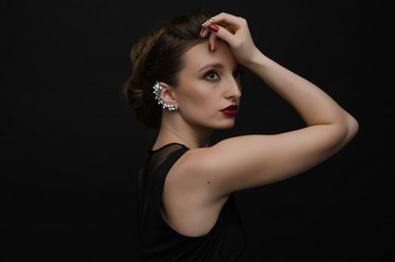 beautiful girl with jewelry on black background