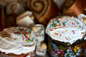 Traditional Russian Easter cakes kulich, with colored eggs, close-up