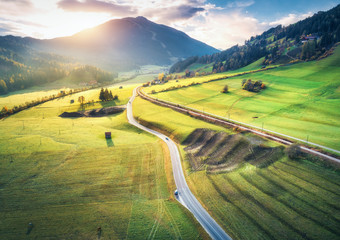 Aerial view of the road in mountain valley at sunset in summer in Dolomites, Italy. Top view of...