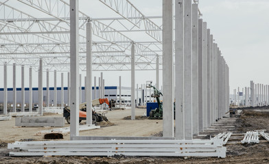 Concrete poles for the construction of the warehouse. Building a new warehouse, industrial concept...
