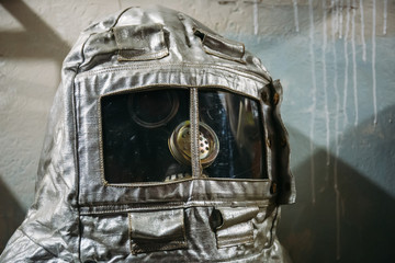 Dummy in gas mask and vintage silver fire suit