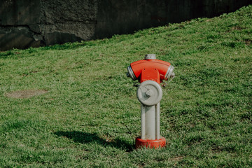 A red hydrant outside. Fire protection concept, connecting a fire hose to the fire hydrant.