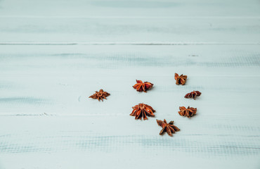 Stars anise on a wooden table. The concept of using seasonings for dishes. Strengthening the taste through spices, better cooking and better taste of dishes.