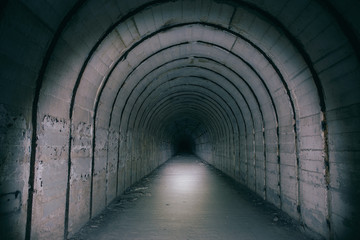 Underground tunnel or corridor in form of arch in abandoned Soviet bomb shelter