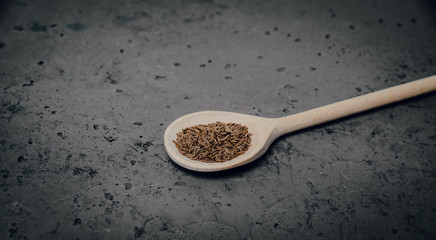 Cumin on a stone table. The concept of using seasonings for dishes. Strengthening the taste through spices, better cooking and better taste of dishes.