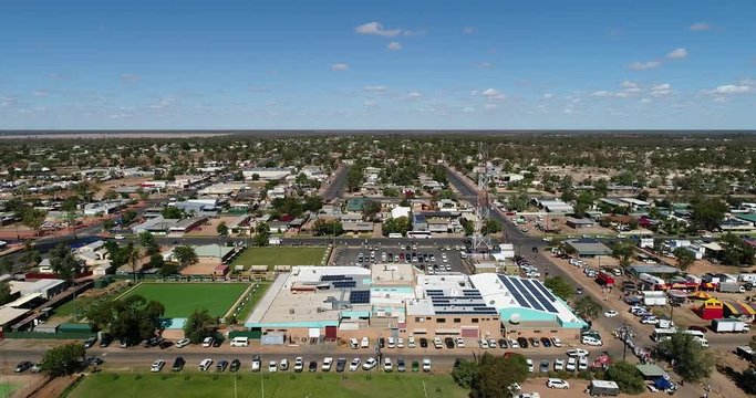 Flat plain around Lightning ridge opal mines town in regional remote NSW seen from above &ndash; elevated aerial flying over town streets.
