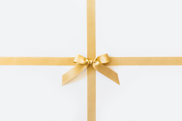Gold ribbon with a bow as a gift on a white background