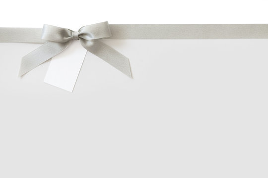 Silver ribbon with a bow as a gift on a white background