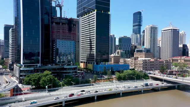 Slow push-in aerial shot towards the Brisbane City Council building on the Brisbane River in Queensland Australia.