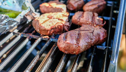 close up of filet mignon cooking on grill