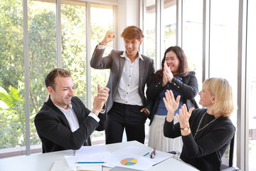 Multiethnic business people discussing company profit or project result in meeting room then they...
