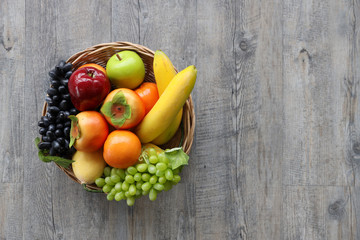 a group of fruits background top view on wood background