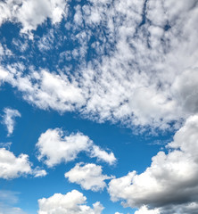 A beautiful blue sky with white puffy clouds.