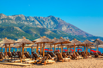 Sandy tropical beach with exotic umbrellas
