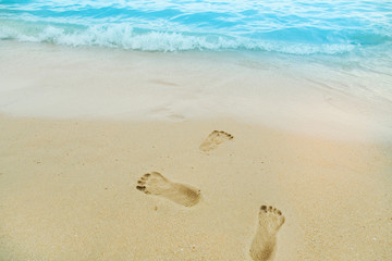 White sand beach with beautiful sea. Footprints in the sand