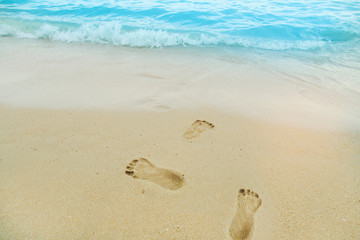 White sand beach with beautiful sea. Footprints in the sand