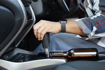 drunk man falling as sleep while driving a car with alcohol bottle beside (drink not drive concept)