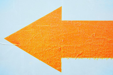 Orange Grunge Arrow Sign on White Background.