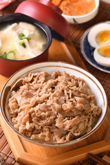 Gyudon - a bowl of rice with sliced beef, onion and sweet sauce. 