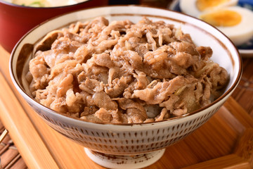 Gyudon - a bowl of rice with sliced beef, onion and sweet sauce. 