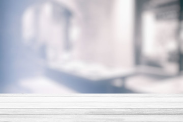 White Wood Table with White Bokeh of Interior Restaurant Room Background, Suitable for Product Display.