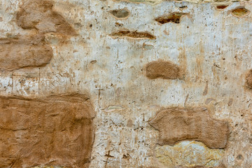 Antique historic mission wall exposed large stones and boulders used during construction